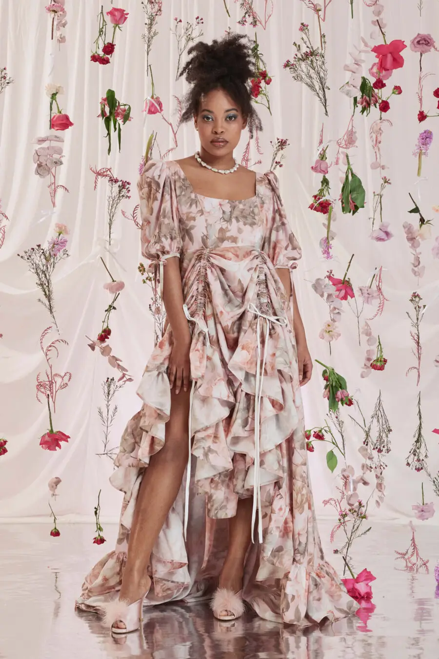 Gloria bustle gown in floral print - DISCLAIMER: Please note that all items within the Archive Sale are not eligible for returns. Some of the items in the Archive Sale may be production samples and may have been used for the collection photoshooting. It may have small flaws, however no rips or anything major that would make the iten unsuitable for wear. If you would like to receive photos of the item you are ordering, please feel free to get in touch and we will gladly photograph it for you.