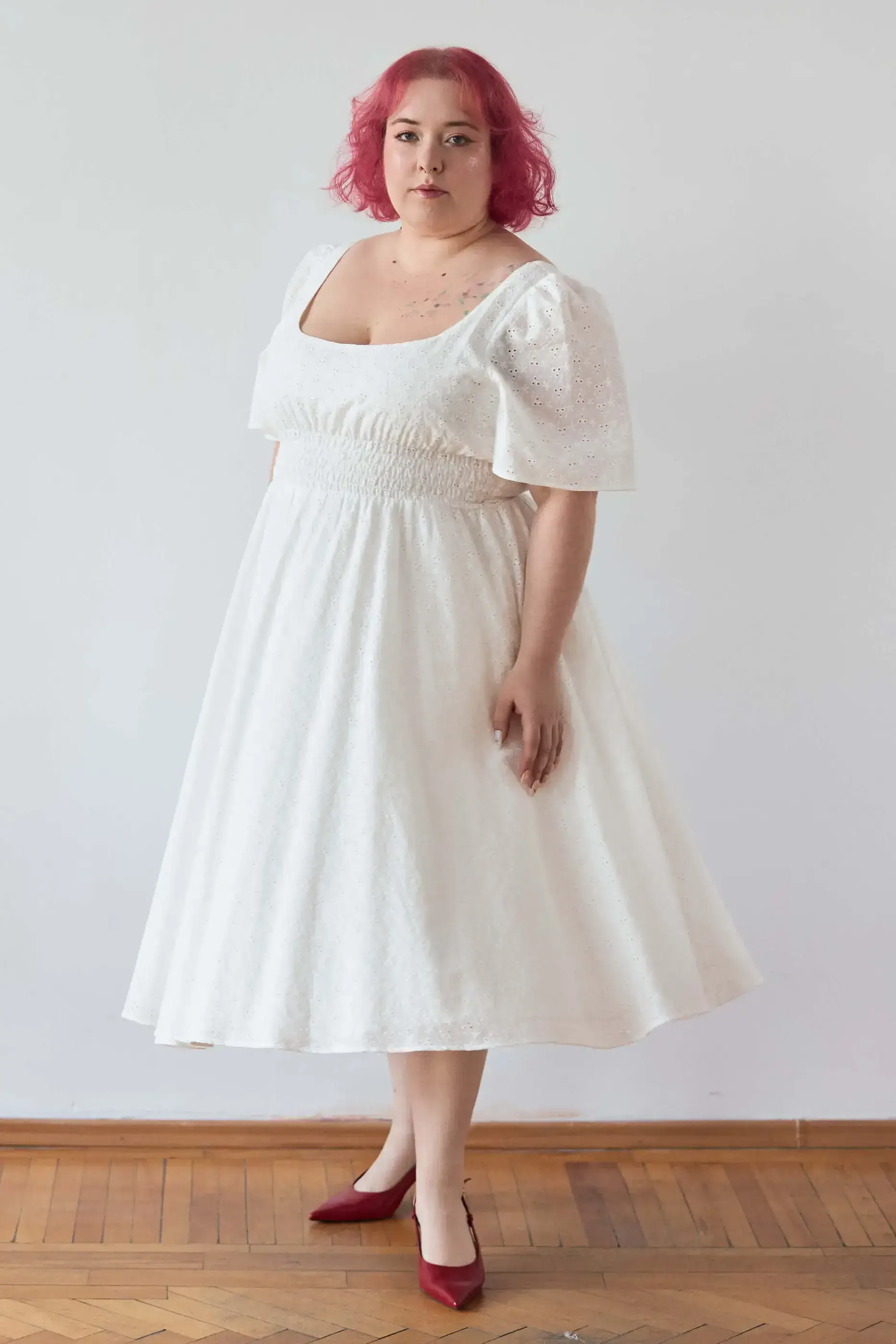 Summer 2025 Audre Ruched Midi Dress In Embroidered White 11 Audre Ruched Midi Dress In Embroidered White Audre ruched midi dress in embroidered white A romantic midi dress with a square neckline, puffed short sleeves, and a comfortable smocked waist, crafted from pink gingham.