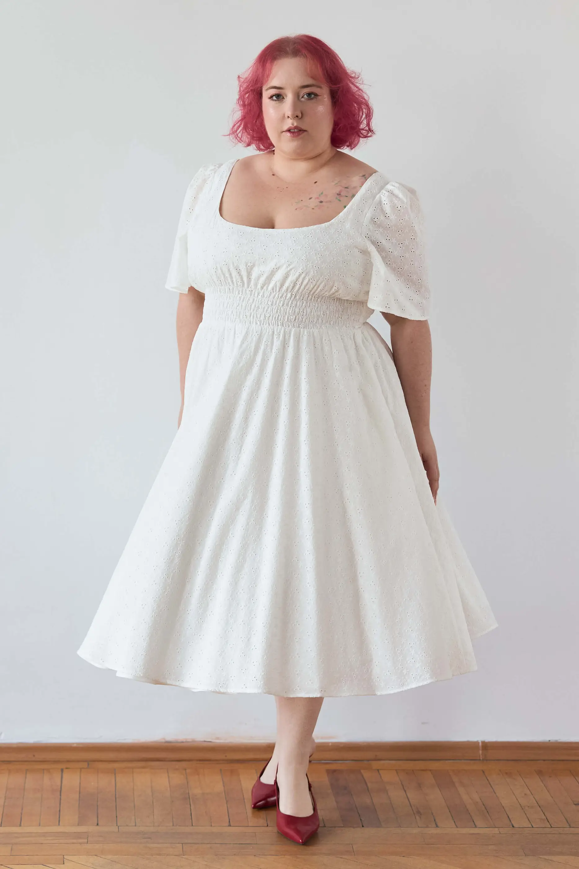 Summer 2025 Audre Ruched Midi Dress In Embroidered White 12 Audre Ruched Midi Dress In Embroidered White Audre ruched midi dress in embroidered white A romantic midi dress with a square neckline, puffed short sleeves, and a comfortable smocked waist, crafted from pink gingham.