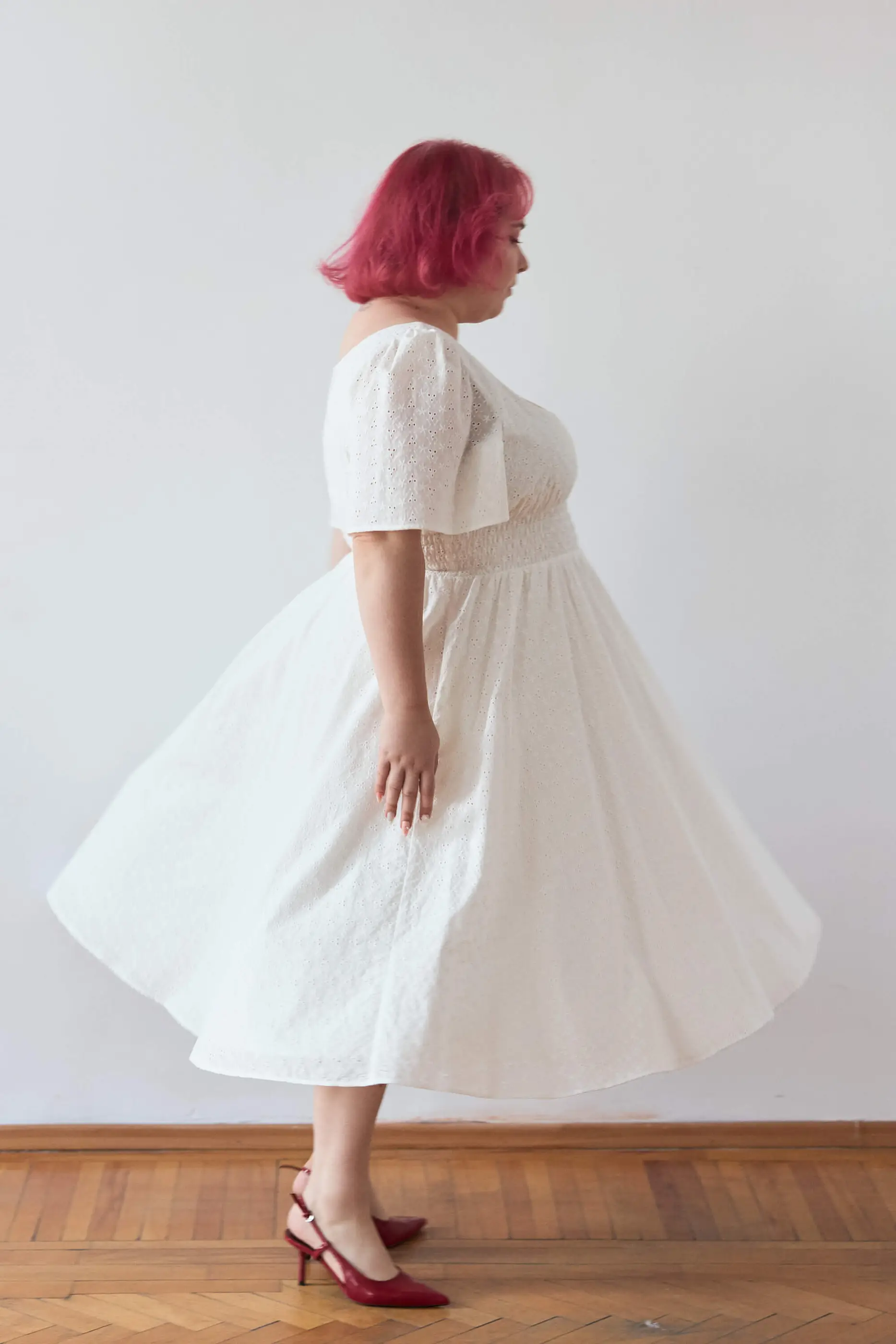 Summer 2025 Audre Ruched Midi Dress In Embroidered White 3 Audre Ruched Midi Dress In Embroidered White Audre ruched midi dress in embroidered white A romantic midi dress with a square neckline, puffed short sleeves, and a comfortable smocked waist, crafted from pink gingham.