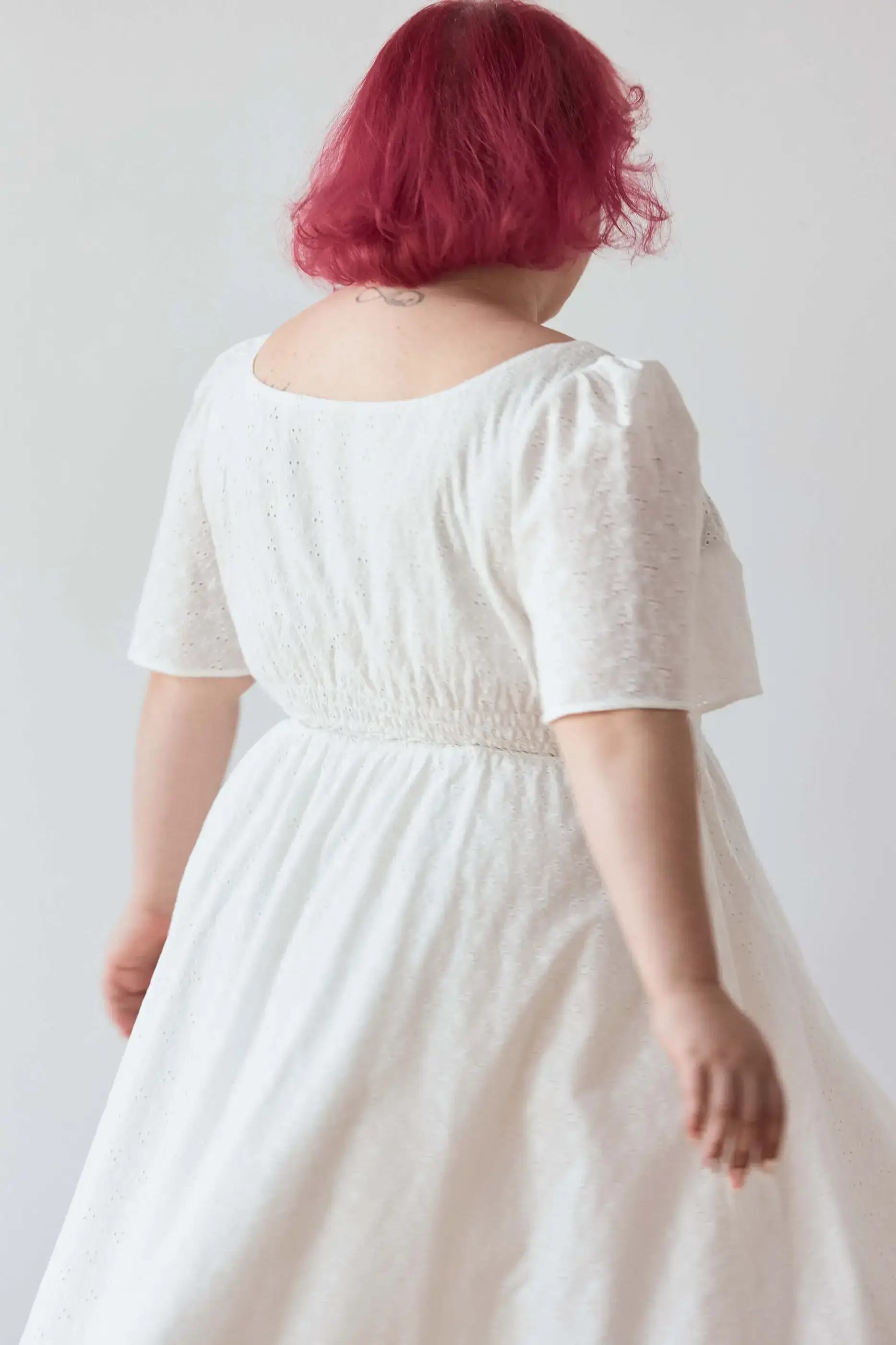 Summer 2025 Audre Ruched Midi Dress In Embroidered White 5 Audre Ruched Midi Dress In Embroidered White Audre ruched midi dress in embroidered white A romantic midi dress with a square neckline, puffed short sleeves, and a comfortable smocked waist, crafted from pink gingham.