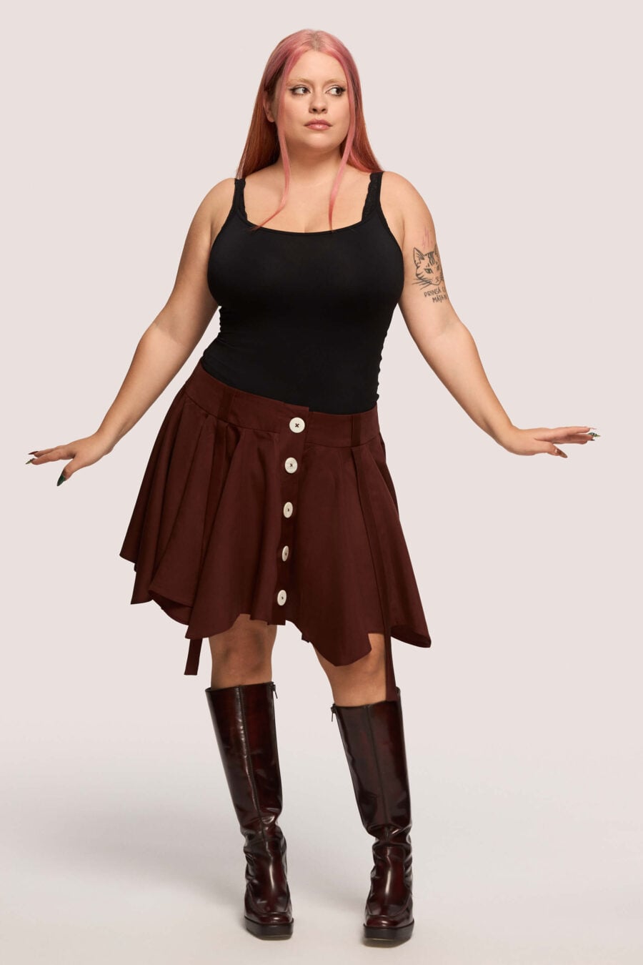 Anonymous mini skirt in bordeaux - Designed to move with you. Sharp lines, soft edges, a little mischief pleated into the hem. A skirt that swings, not for attention, but for joy.