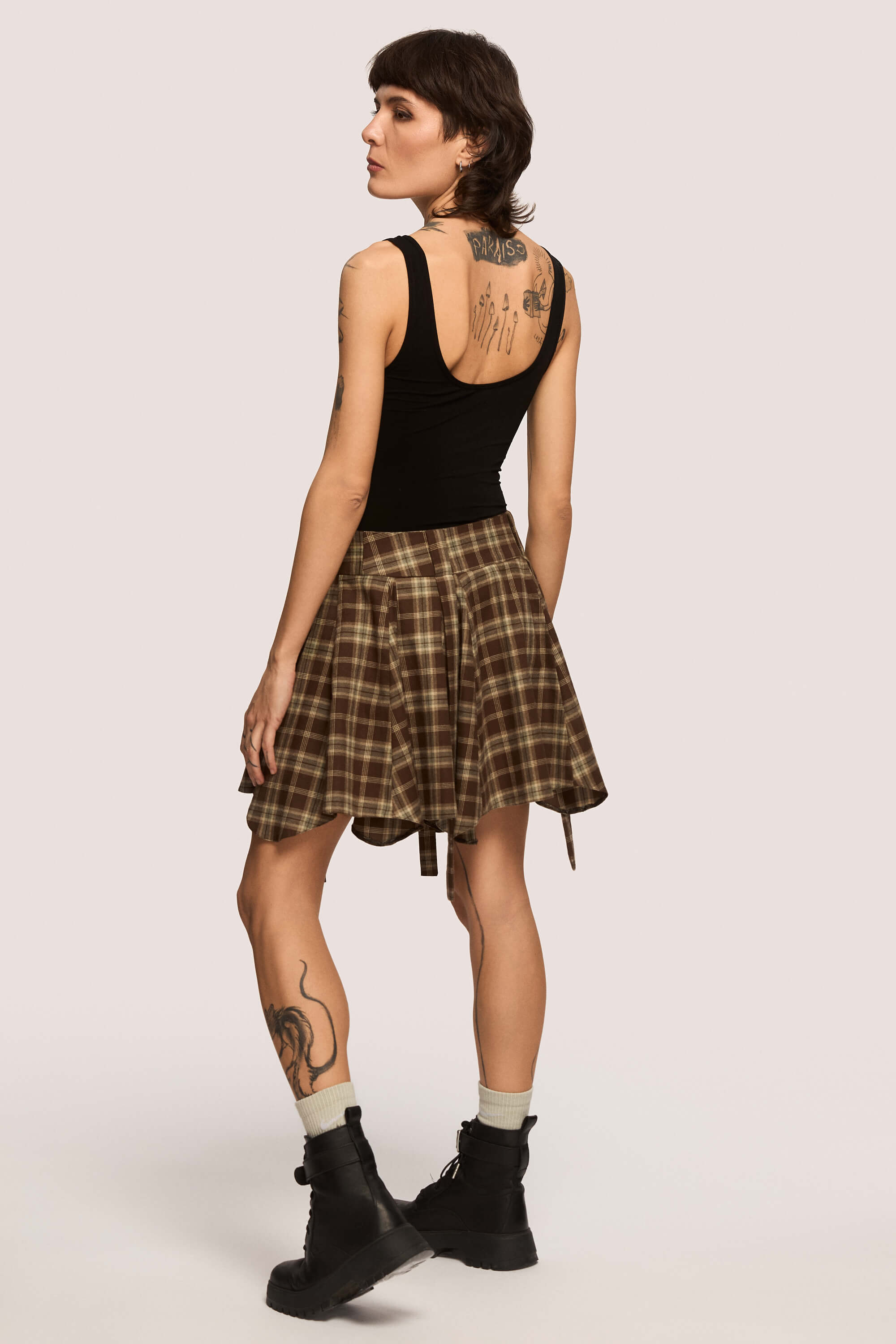 Winter 2025 Anonymous Mini Skirt In Chestnut Plaid 5 Anonymous Mini Skirt In Chestnut Plaid Anonymous mini skirt in chestnut plaid Designed to move with you. Sharp lines, soft edges, a little mischief pleated into the hem. A skirt that swings, not for attention, but for joy.