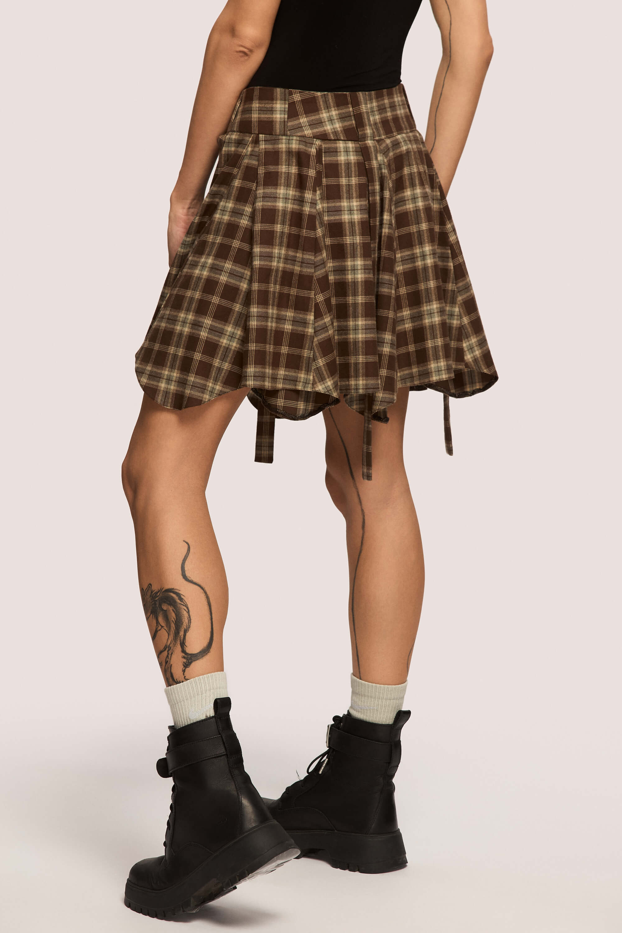 Winter 2025 Anonymous Mini Skirt In Chestnut Plaid 6 Anonymous Mini Skirt In Chestnut Plaid Anonymous mini skirt in chestnut plaid Designed to move with you. Sharp lines, soft edges, a little mischief pleated into the hem. A skirt that swings, not for attention, but for joy.