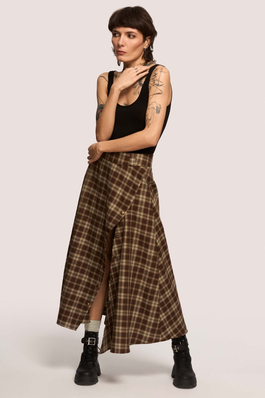 The Vegetarian midi skirt in chestnut plaid  Made to hold you without squeezing, a shape that follows your rhythm, not the world’s expectations. For long walks, long talks, the long sigh of relief when you finally get home.