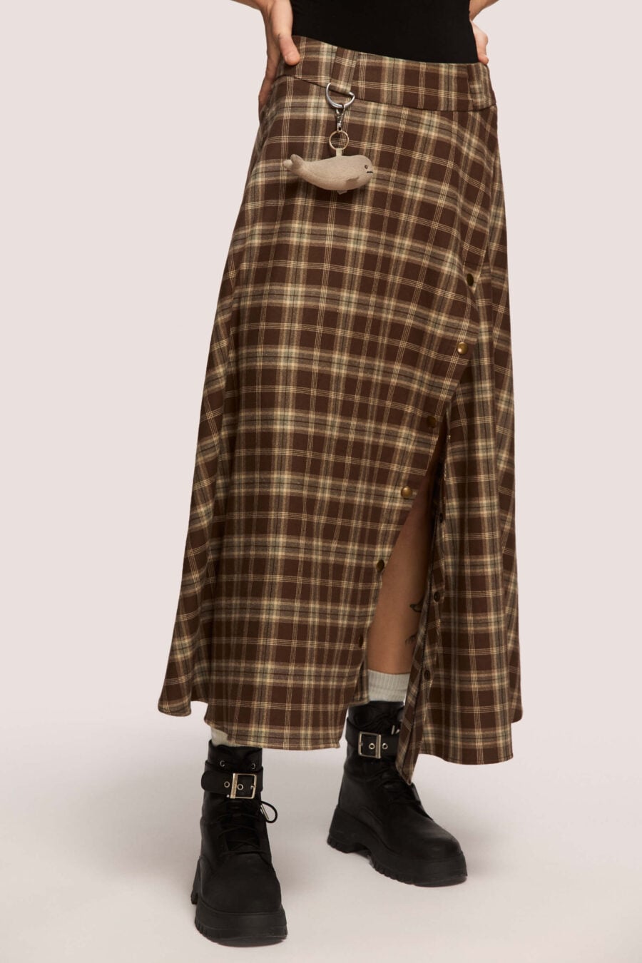 The Vegetarian midi skirt in chestnut plaid - Made to hold you without squeezing, a shape that follows your rhythm, not the world’s expectations. For long walks, long talks, the long sigh of relief when you finally get home.