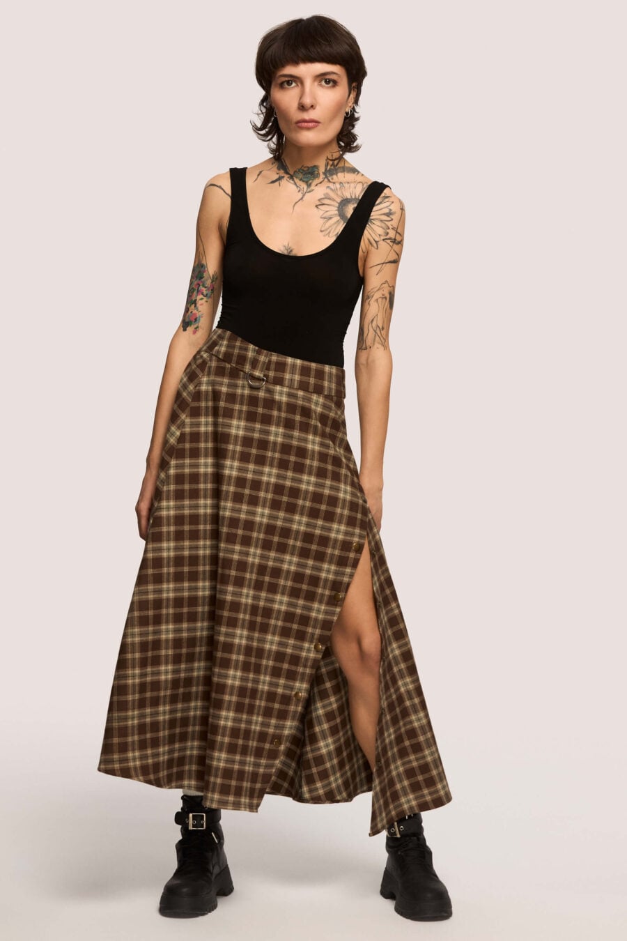 The Vegetarian midi skirt in chestnut plaid - Made to hold you without squeezing, a shape that follows your rhythm, not the world’s expectations. For long walks, long talks, the long sigh of relief when you finally get home.