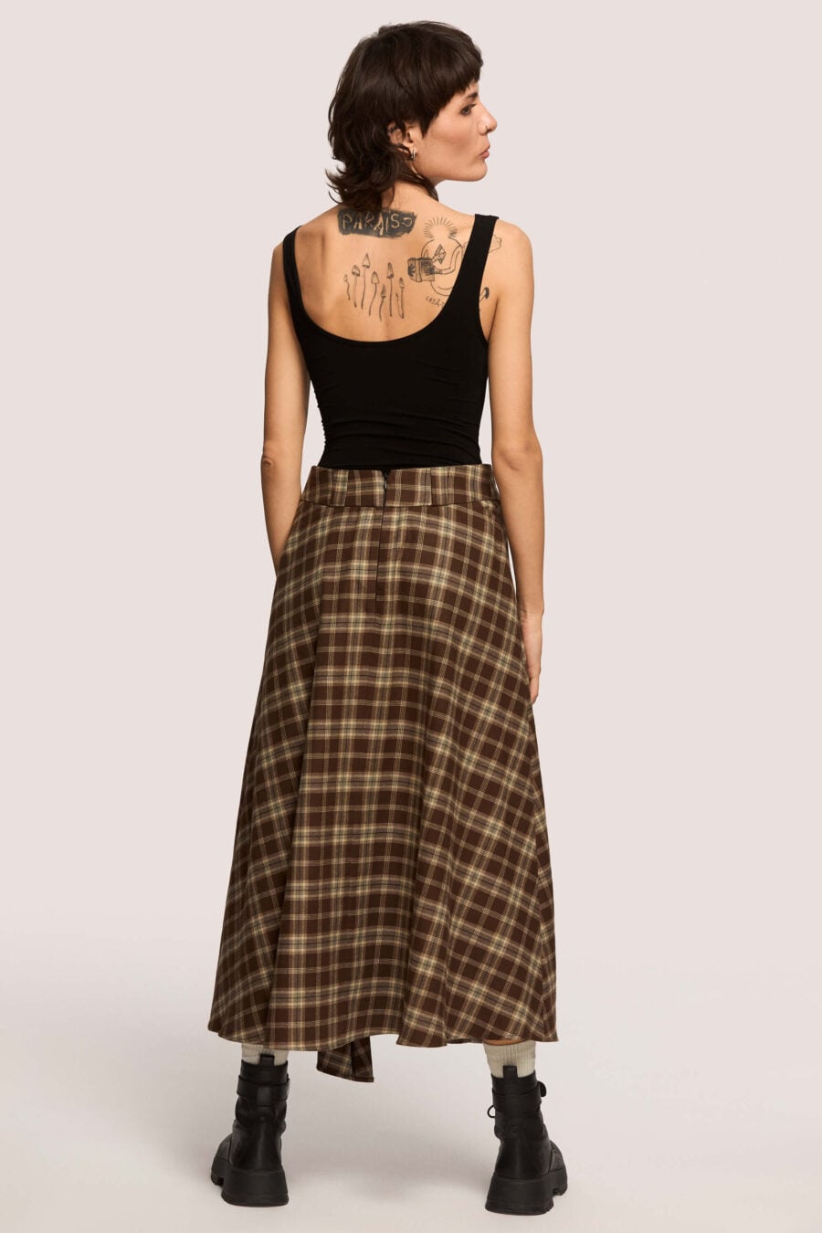 The Vegetarian midi skirt in chestnut plaid - Made to hold you without squeezing, a shape that follows your rhythm, not the world’s expectations. For long walks, long talks, the long sigh of relief when you finally get home.