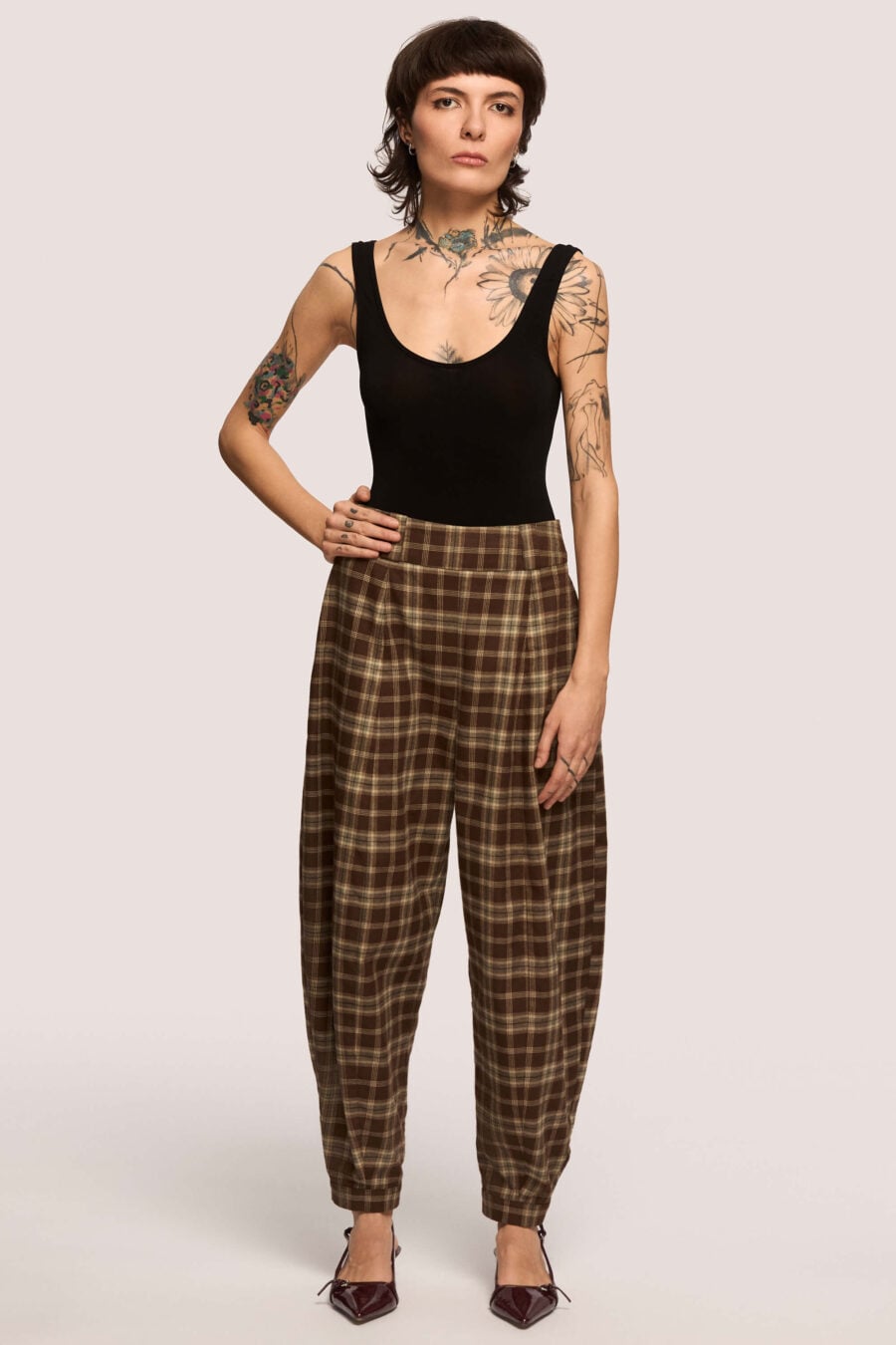 Troublemaker barrel leg pants in chestnut plaid - Designed for sitting, pacing, speaking up, walking away – a shape that shifts with you, not against you, with room for everything you carry. A fit that stays kind, even when the day isn’t.