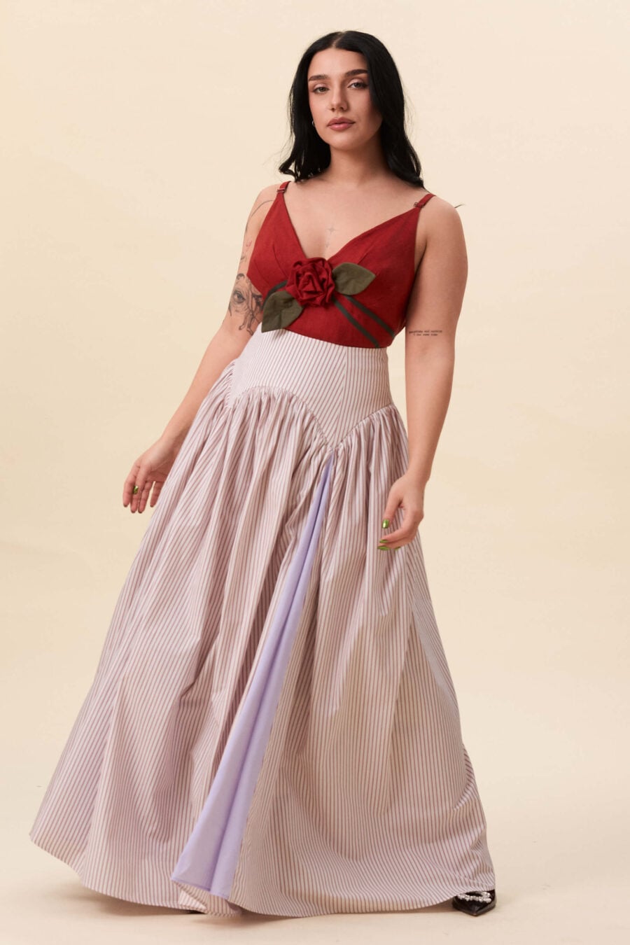 Cordelia Gray maxi skirt in red stripes - The waist holds a fitted structure before releasing into a full, gathered skirt. Contrasting panels at the front and back shape the silhouette, introducing variation and rhythm as the garment moves.