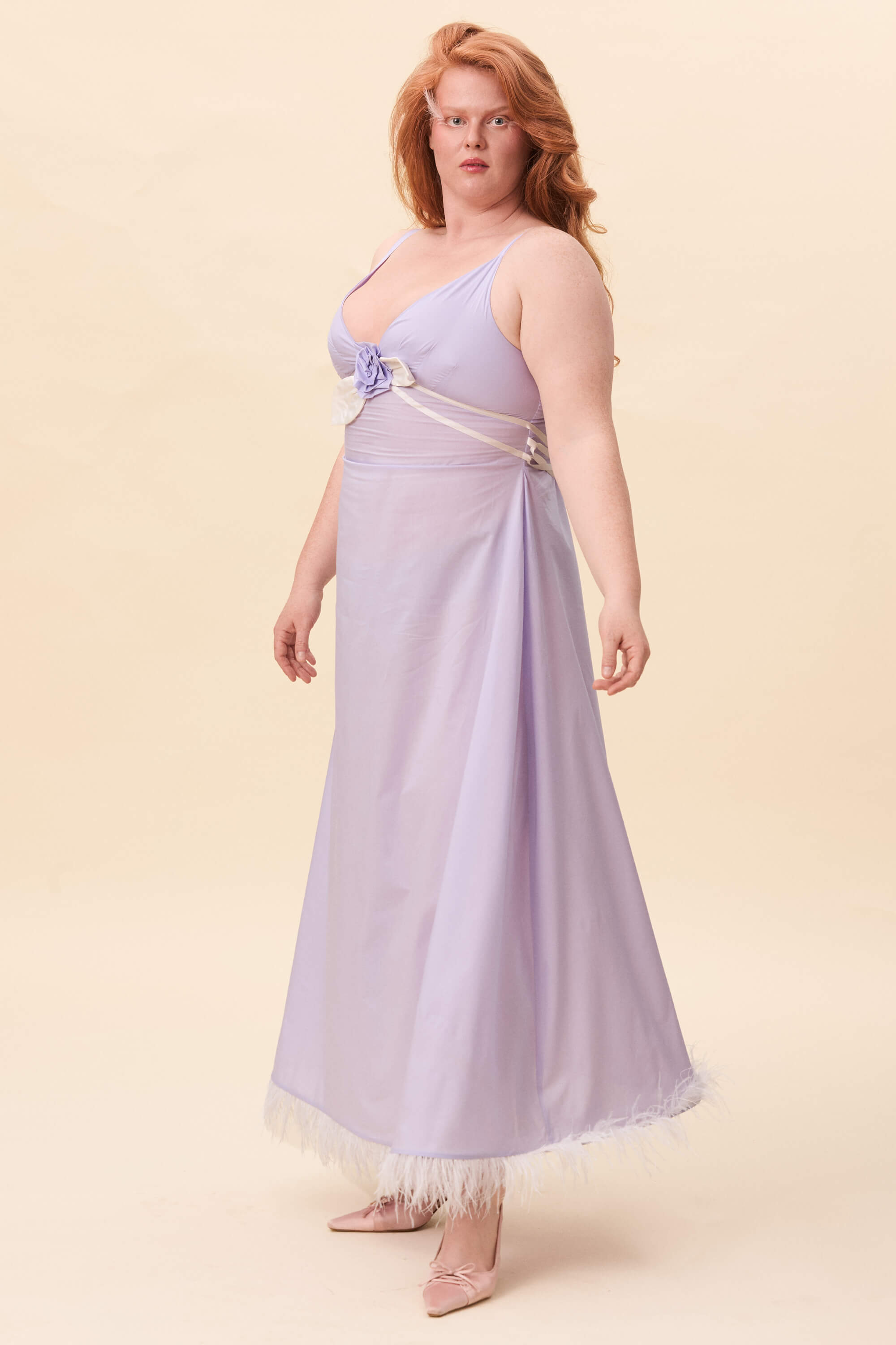 Spring 2026 Gone Girl Slip Dress In Lavender Voille 6 Gone Girl Slip Dress In Lavender Voille Gone Girl slip dress in lavender voille An elongated silhouette designed to move with ease. The focus gathers at the bust, to a sculptural rose from which two slender lines fall, guiding the eye downward and wrapping into a corset at the back. Form shaped through tension and release.