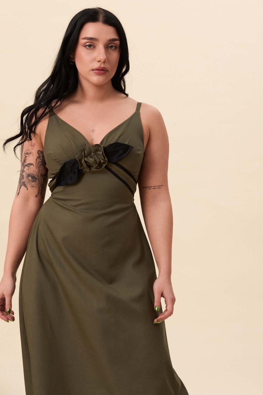 Gone Girl slip dress in olive green - An elongated silhouette designed to move with ease. The focus gathers at the bust, to a sculptural rose from which two slender lines fall, guiding the eye downward and wrapping into a corset at the back. Form shaped through tension and release.