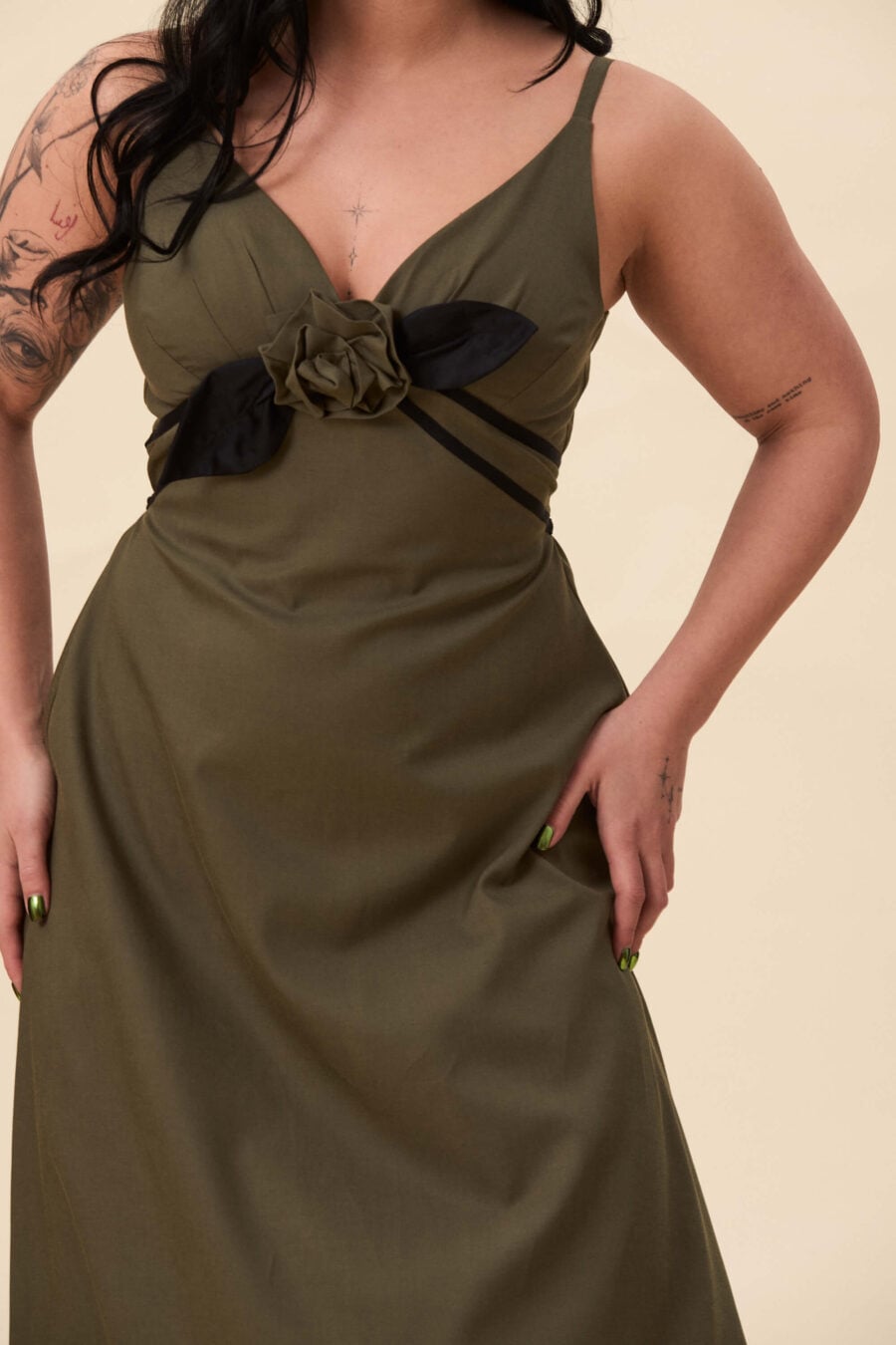 Gone Girl slip dress in olive green - An elongated silhouette designed to move with ease. The focus gathers at the bust, to a sculptural rose from which two slender lines fall, guiding the eye downward and wrapping into a corset at the back. Form shaped through tension and release.