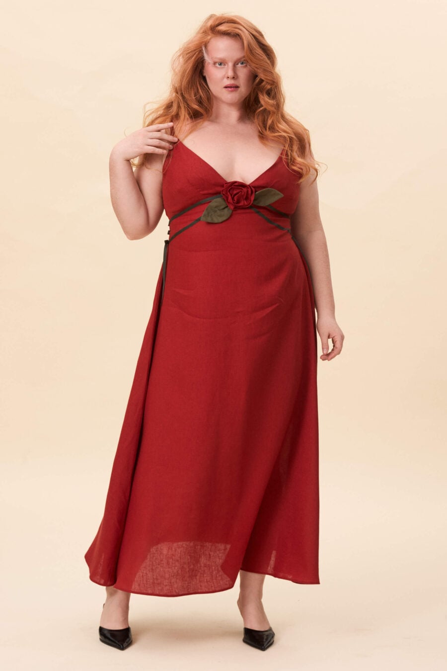 Gone Girl slip dress in tomato red - An elongated silhouette designed to move with ease. The focus gathers at the bust, to a sculptural rose from which two slender lines fall, guiding the eye downward and wrapping into a corset at the back. Form shaped through tension and release.