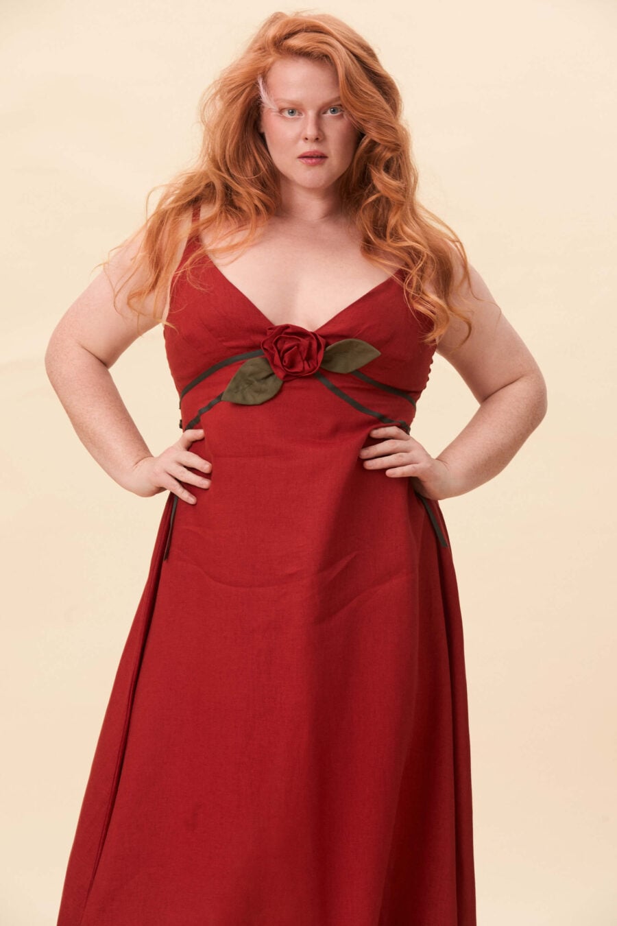 Gone Girl slip dress in tomato red - An elongated silhouette designed to move with ease. The focus gathers at the bust, to a sculptural rose from which two slender lines fall, guiding the eye downward and wrapping into a corset at the back. Form shaped through tension and release.
