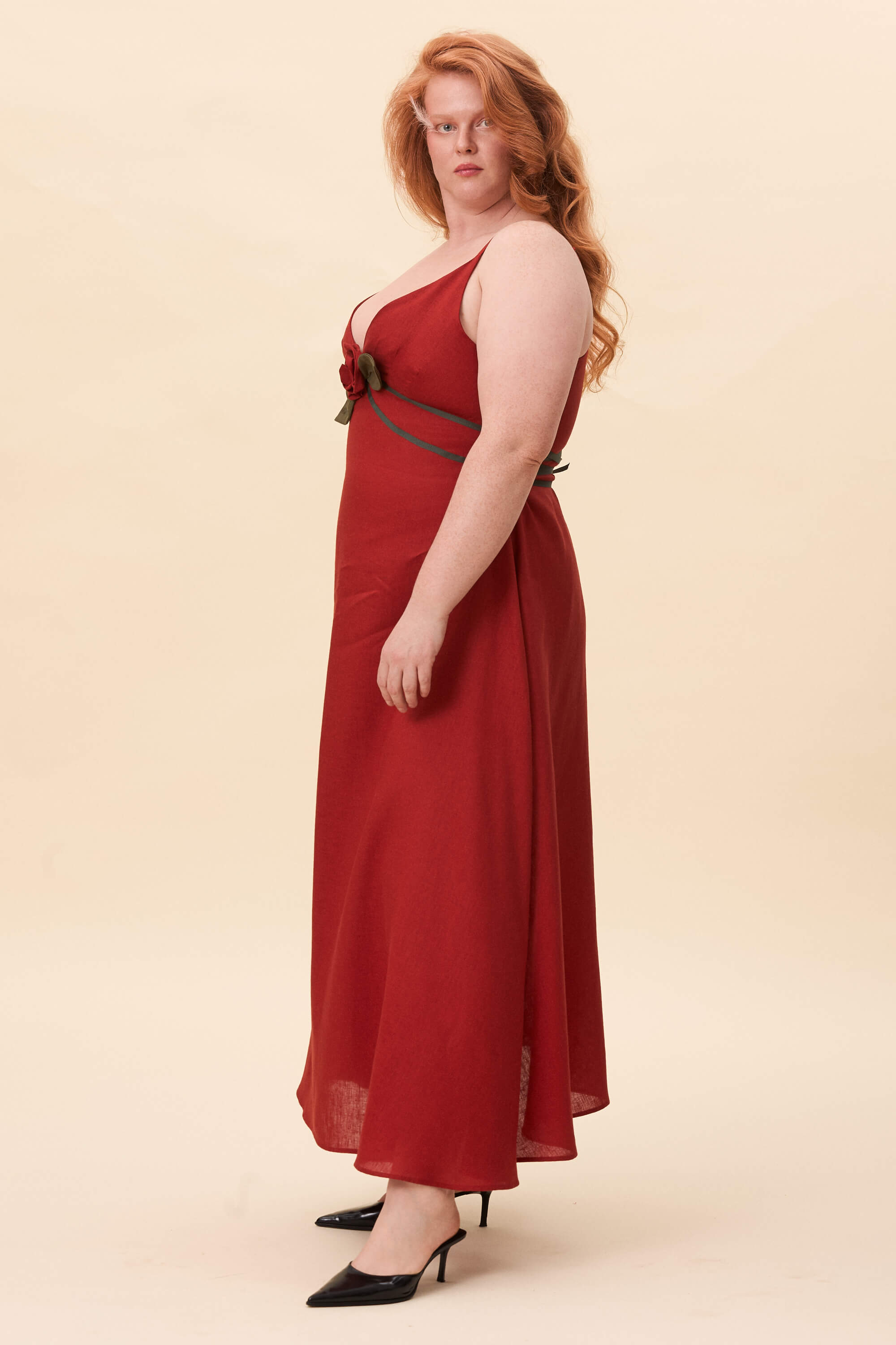 Spring 2026 Gone Girl Slip Dress In Tomato Red 4 Gone Girl Slip Dress In Tomato Red Gone Girl slip dress in tomato red An elongated silhouette designed to move with ease. The focus gathers at the bust, to a sculptural rose from which two slender lines fall, guiding the eye downward and wrapping into a corset at the back. Form shaped through tension and release.