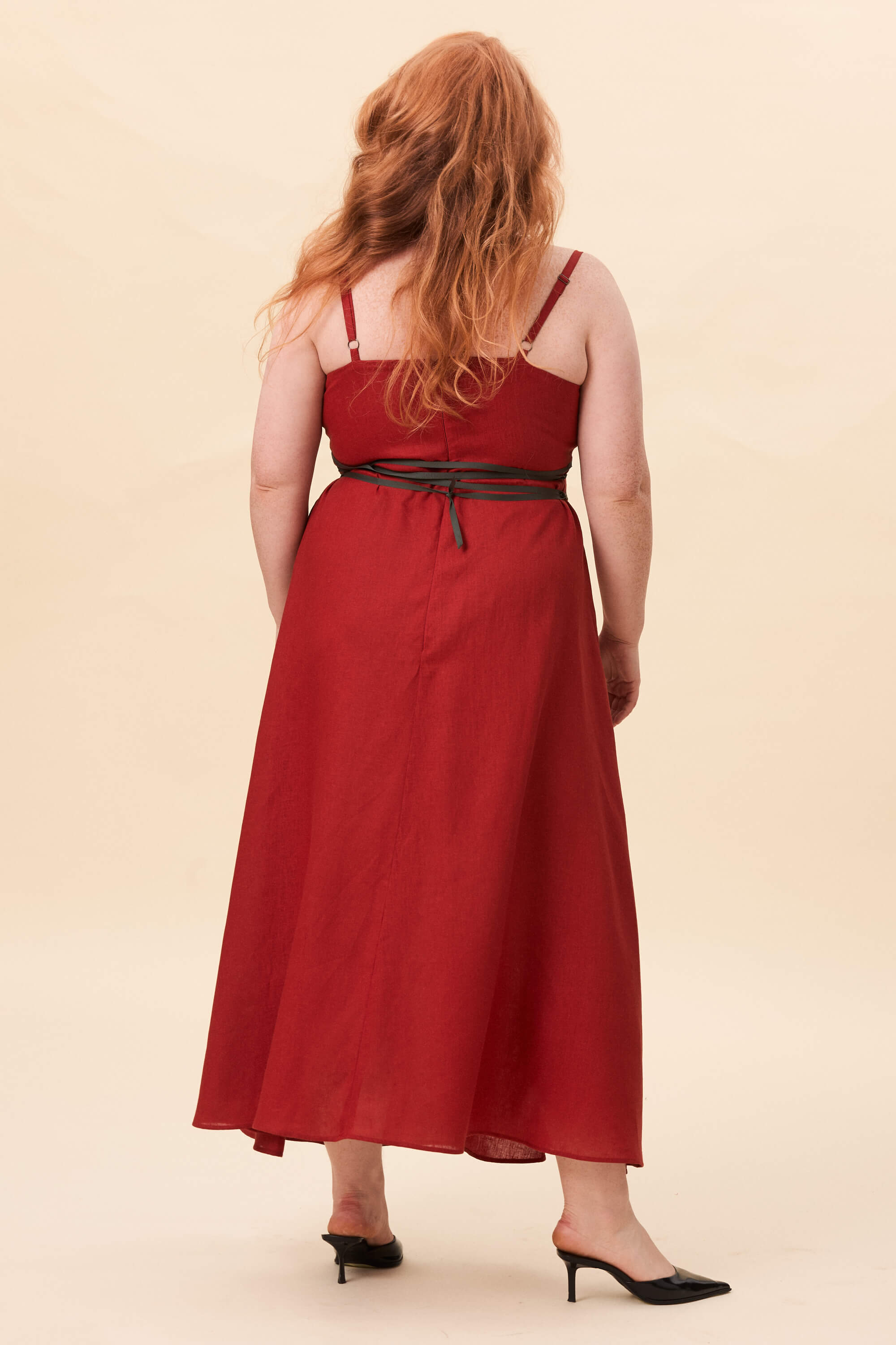 Spring 2026 Gone Girl Slip Dress In Tomato Red 5 Gone Girl Slip Dress In Tomato Red Gone Girl slip dress in tomato red An elongated silhouette designed to move with ease. The focus gathers at the bust, to a sculptural rose from which two slender lines fall, guiding the eye downward and wrapping into a corset at the back. Form shaped through tension and release.