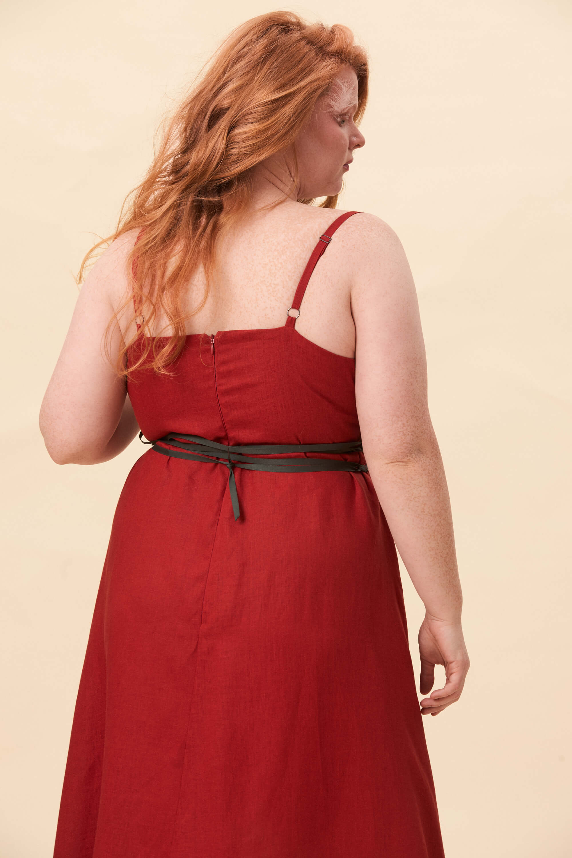 Spring 2026 Gone Girl Slip Dress In Tomato Red 6 Gone Girl Slip Dress In Tomato Red Gone Girl slip dress in tomato red An elongated silhouette designed to move with ease. The focus gathers at the bust, to a sculptural rose from which two slender lines fall, guiding the eye downward and wrapping into a corset at the back. Form shaped through tension and release.