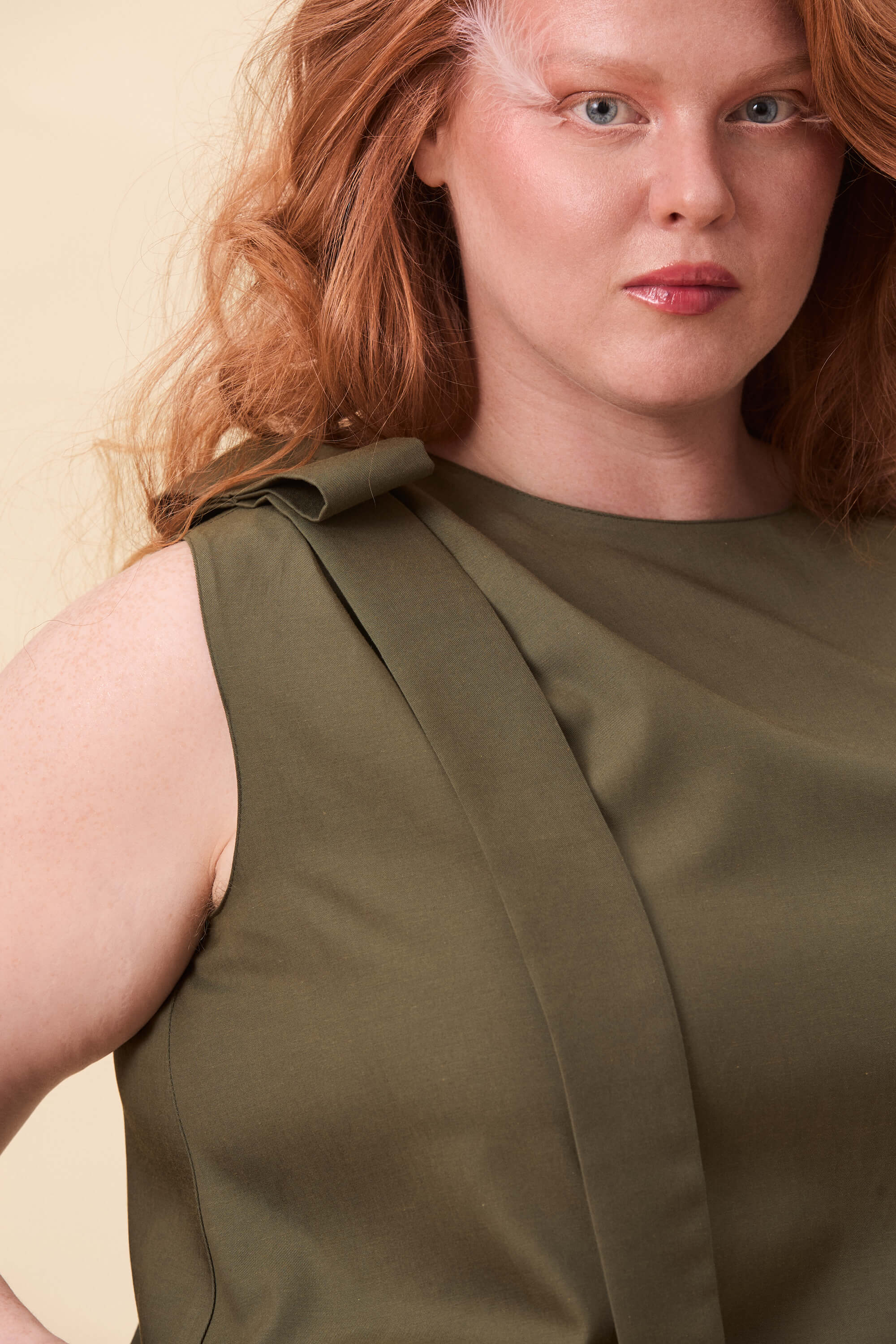 Spring 2026 Harriet Vane Top In Olive Green 3 Harriet Vane Top In Olive Green Harriet Vane top in olive green A sleeveless top with a clean, uninterrupted front. The silhouette is relaxed, allowing it to fall naturally or be tucked for a more defined shape. A narrow tie detail sits at the side, introducing structure without altering the clean lines.