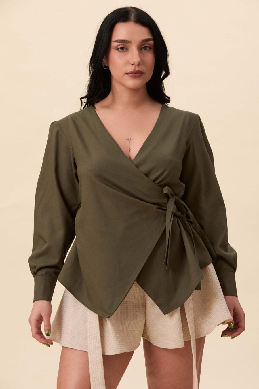 Strong Poison wrap shirt in olive green - A wrap shirt shaped through angled lines rather than volume. The front crosses into a sharp, pointed hem, fastening with slender ties at the side. Sleeves are softly structured, finished with extended cuffs.