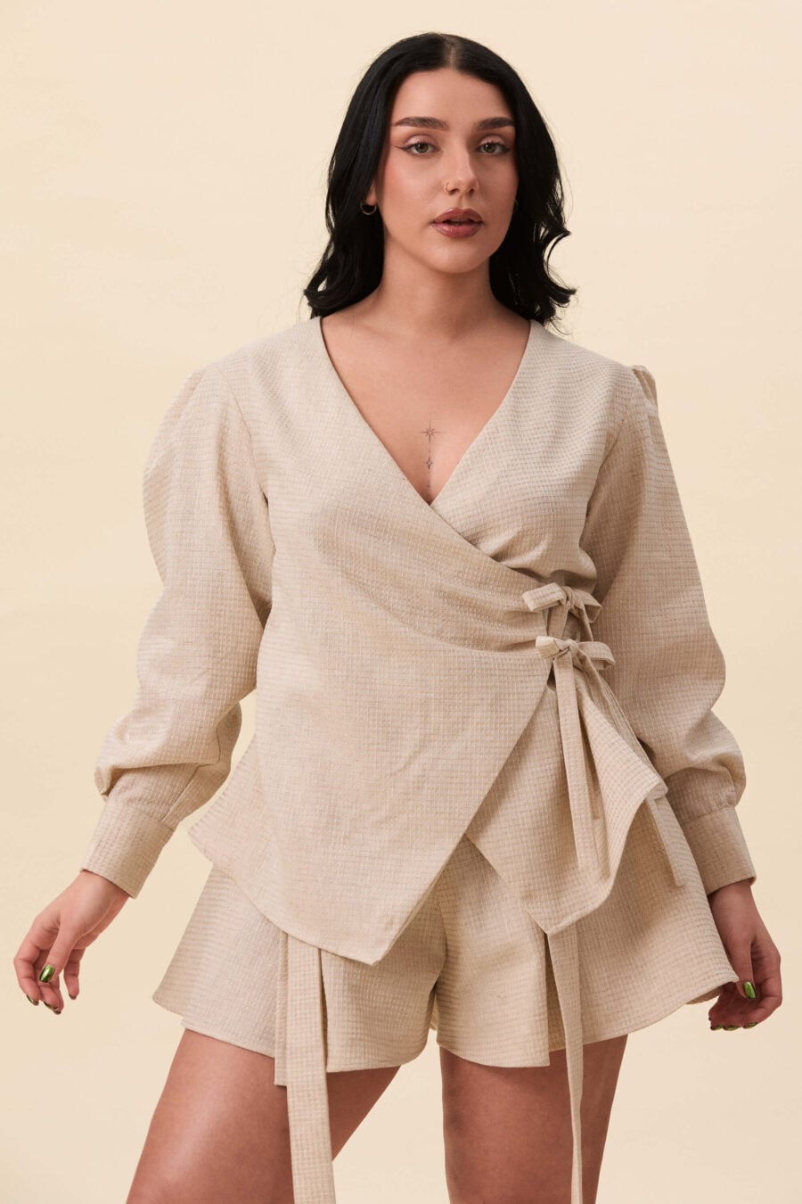 Strong Poison wrap shirt in textured beige - A wrap shirt shaped through angled lines rather than volume. The front crosses into a sharp, pointed hem, fastening with slender ties at the side. Sleeves are softly structured, finished with extended cuffs.